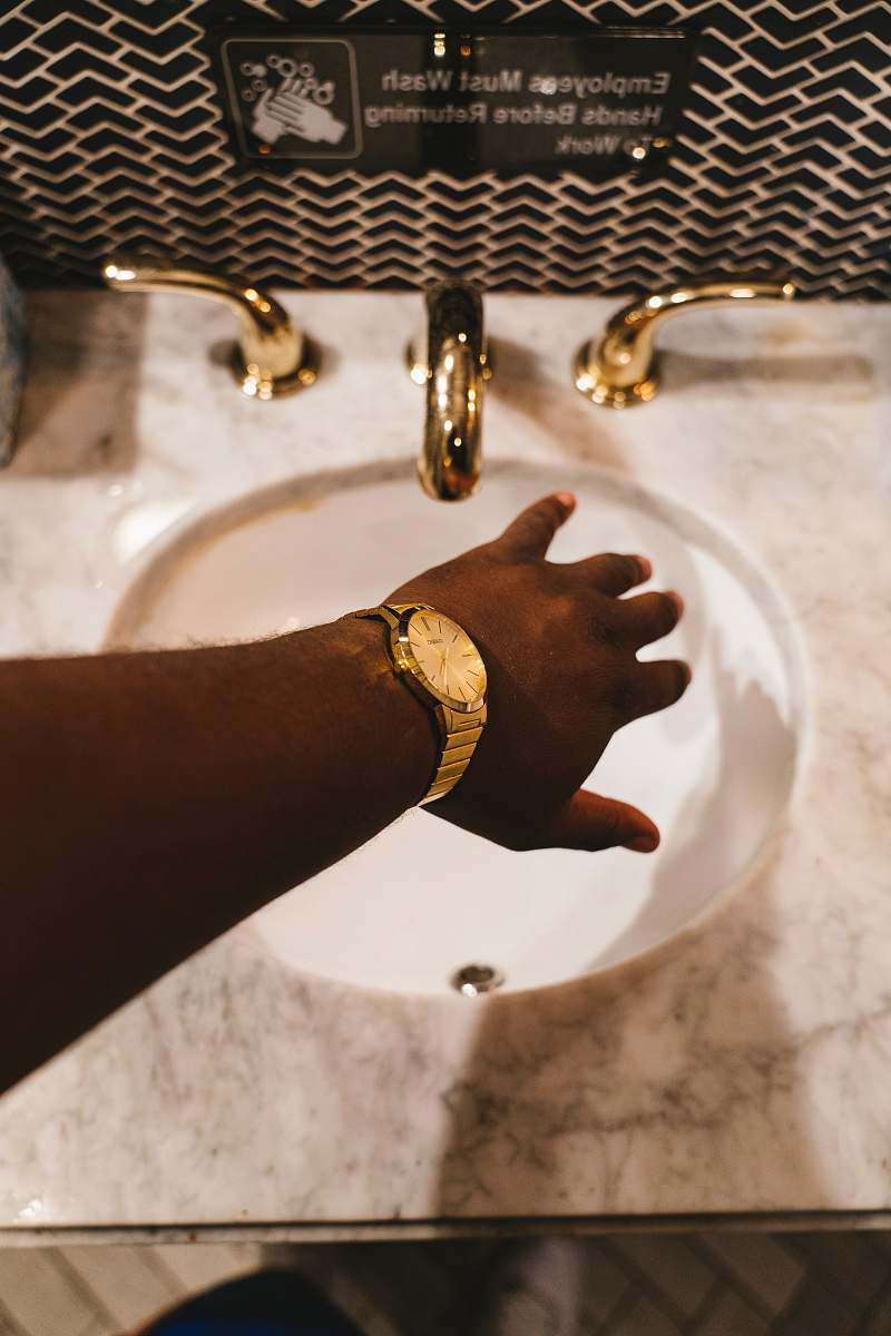 sink person about to hold faucet in a sink new york